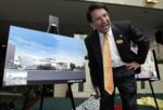 Then-Mayor Pat McCrory smiles as he talks about an artist's rendition of the city's NASCAR's Hall of Fame (located in the former Brooklyn neighborhood), during a public unveiling in 2005.