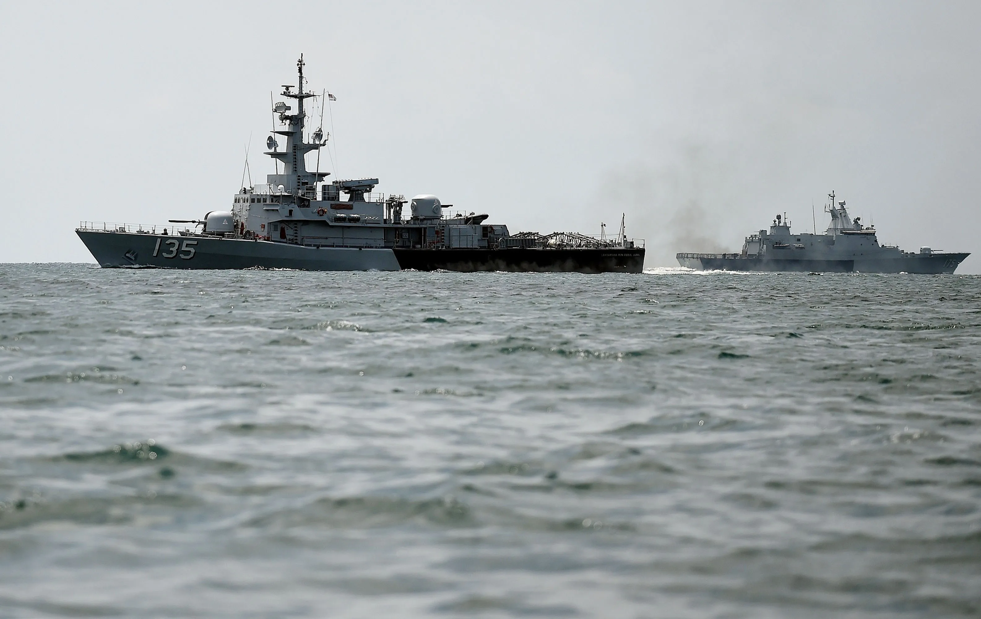 Royal Malaysian Navy ships patrol the border.
