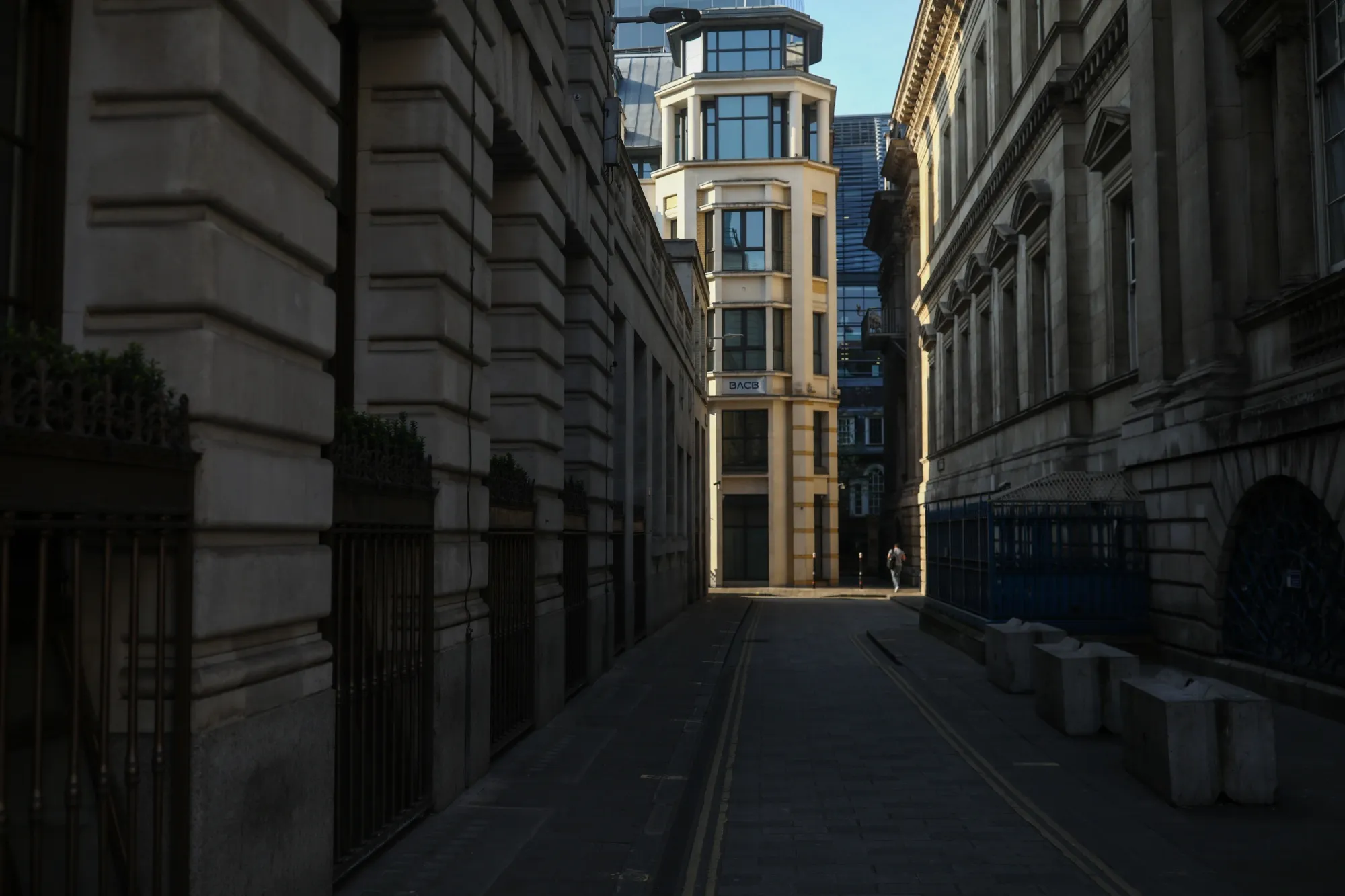 A lone pedestrian walks down an alleyway in the City of London on April 9.