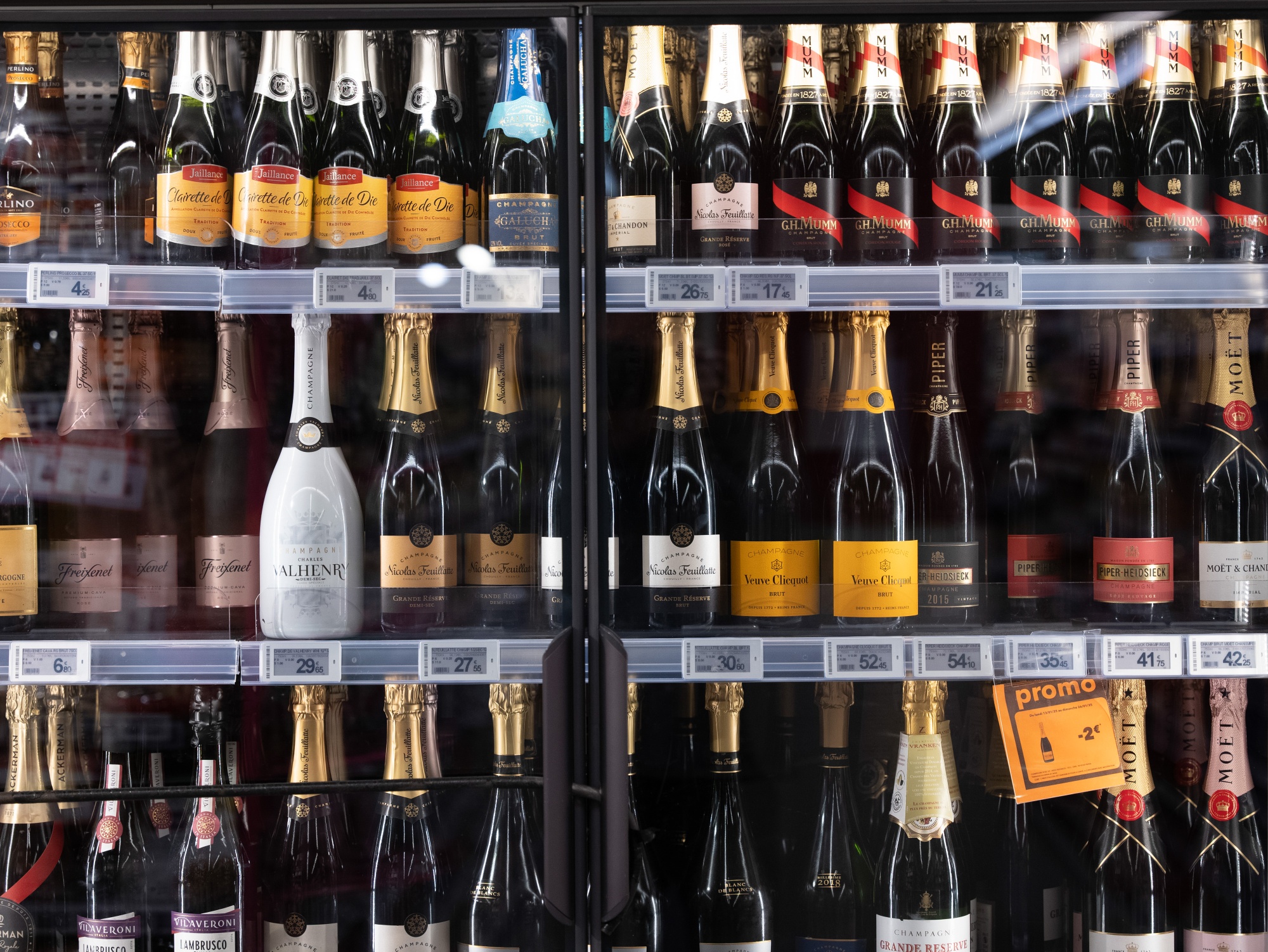 French champagne bottles in a refrigerated display cabinet at a store in Marseille, France.Photographer: Jeremy Suyker/Bloomberg