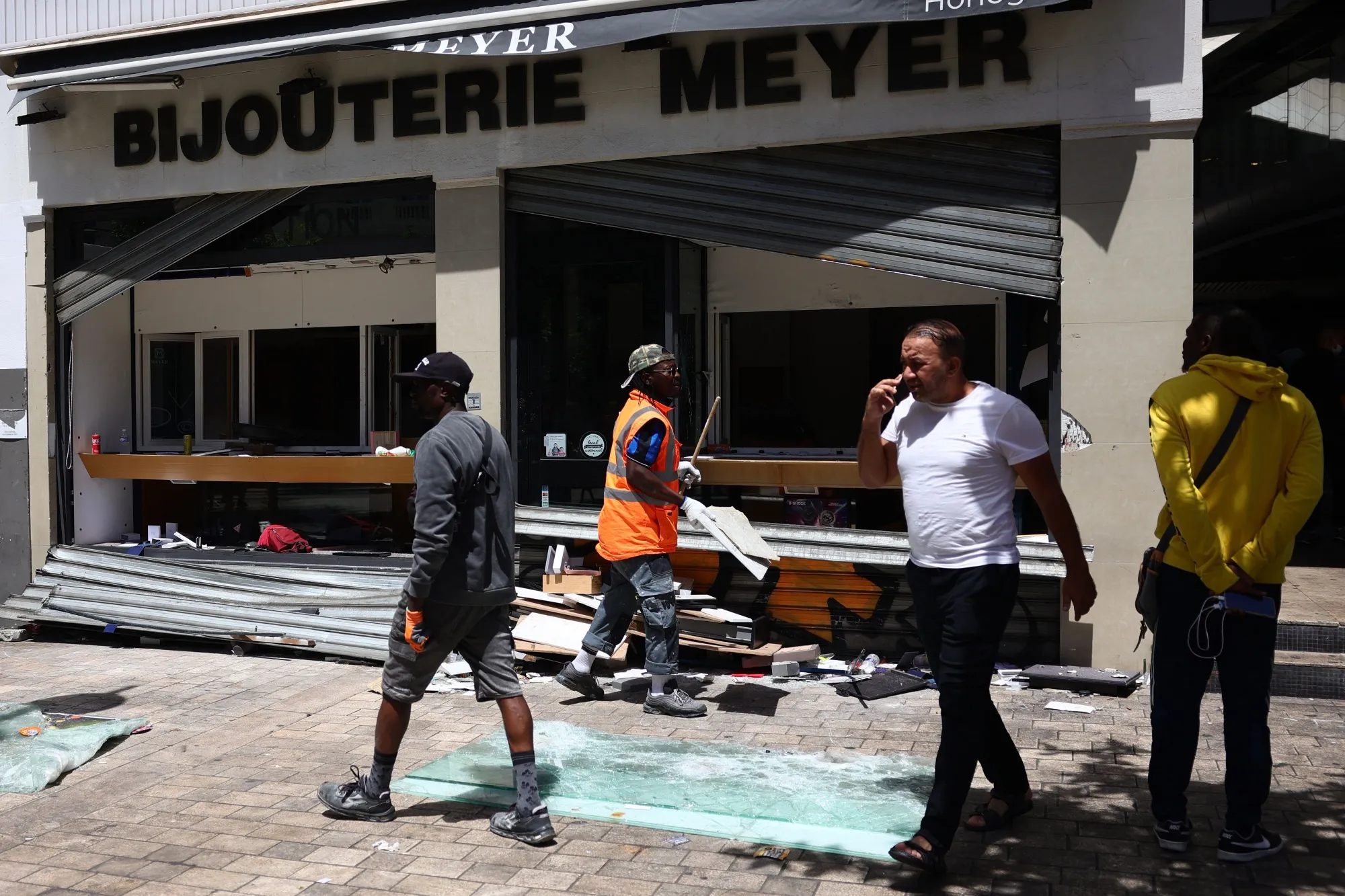 A worker cleans debris of a looted&nbsp;store in the centre of Marseille.&nbsp;