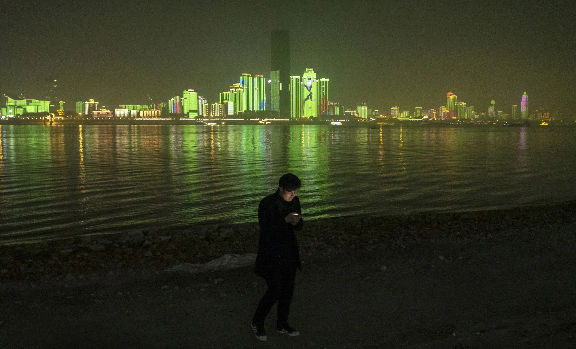 A visitor&nbsp;on the shores of the Yangtze River&nbsp;in Wuhan, Hubei Province, China.