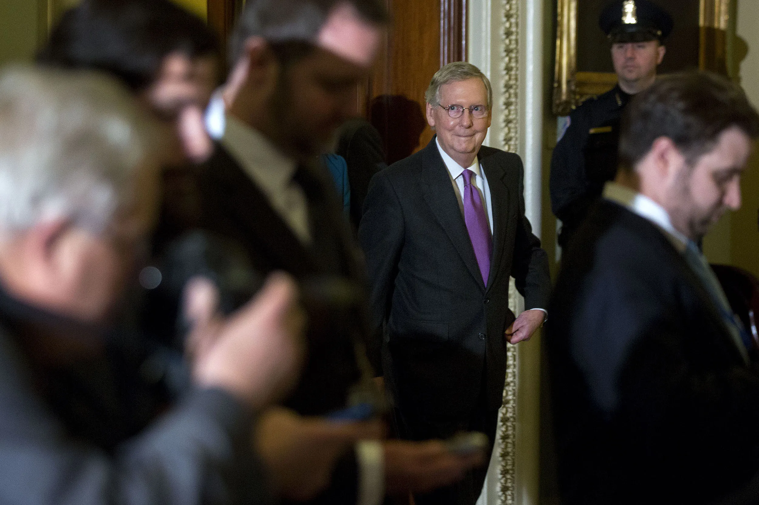 Senate Majority Leader Mitch McConnell, a Republican from Kentucky, center, arrives to a news conference after a cloture vote on the Keystone XL pipeline bill at the U.S. Capitol in Washington, D.C., U.S., on Jan. 29, 2015.
