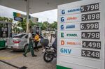 Workers fuel vehicles at a Petrobras station in Rio de Janeiro.