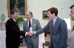 President Reagan shakes hands with Robert Lighthizer during a meeting for a Cabinet Affairs briefing in the Oval Office with Malcolm Baldrige, April 25, 1983.