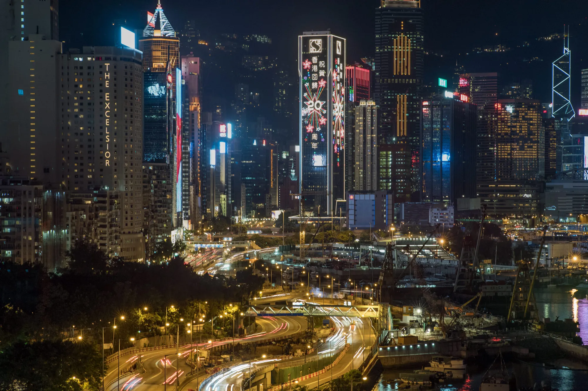 Light displays celebrating the 20th anniversary of Hong Kong's handover from Britain to China are shown on building facades ahead of Chinese President Xi Jinping's arrival in Hong Kong, China, on Wednesday, June 28, 2017. Hong Kong is making preparations to mark the 20th anniversary of the former British colony's return to Chinese rule, with July 1 marking the first time Xi will visit the city since taking office.
