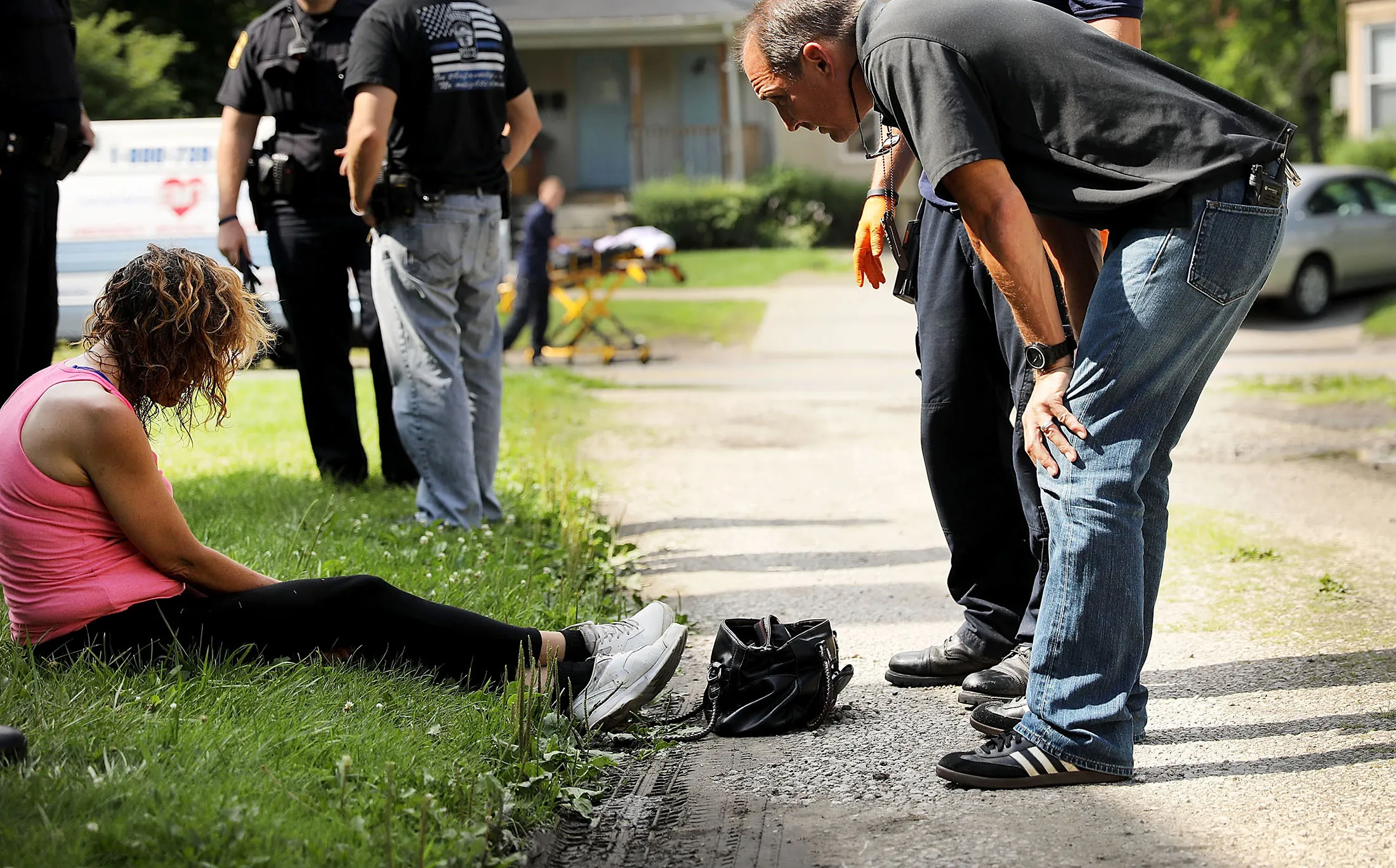 Medical workers and police treat a woman who has overdosed on heroin, the second case in a matter of minutes, in Warren, Ohio.