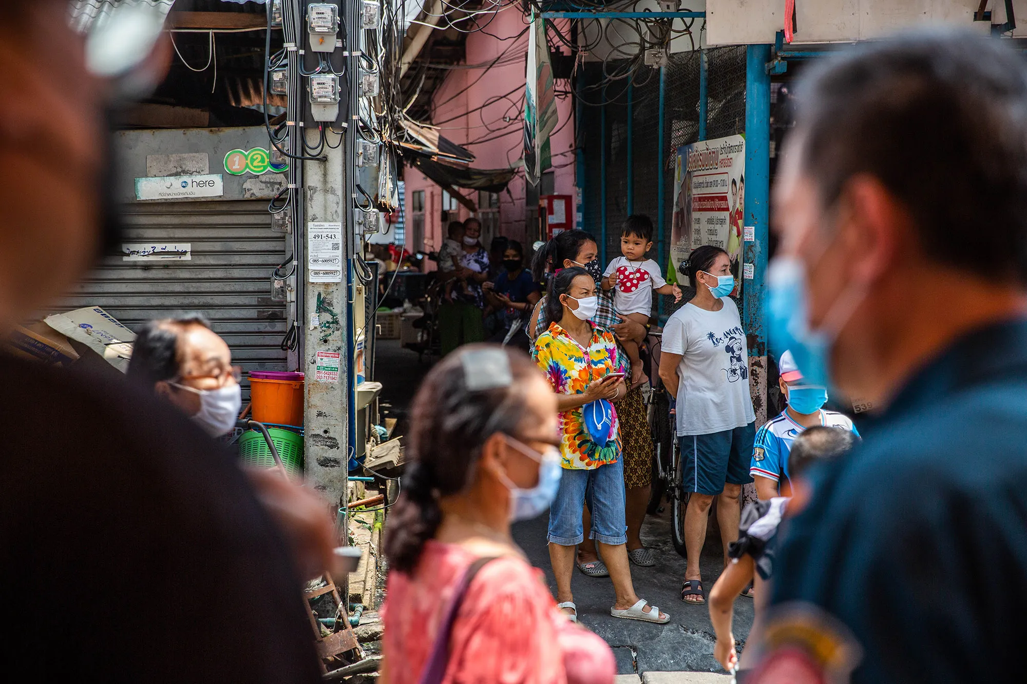 People wait to receive food, water and masks from the Poh Tek Tung Foundation, in Bangkok on April 22.