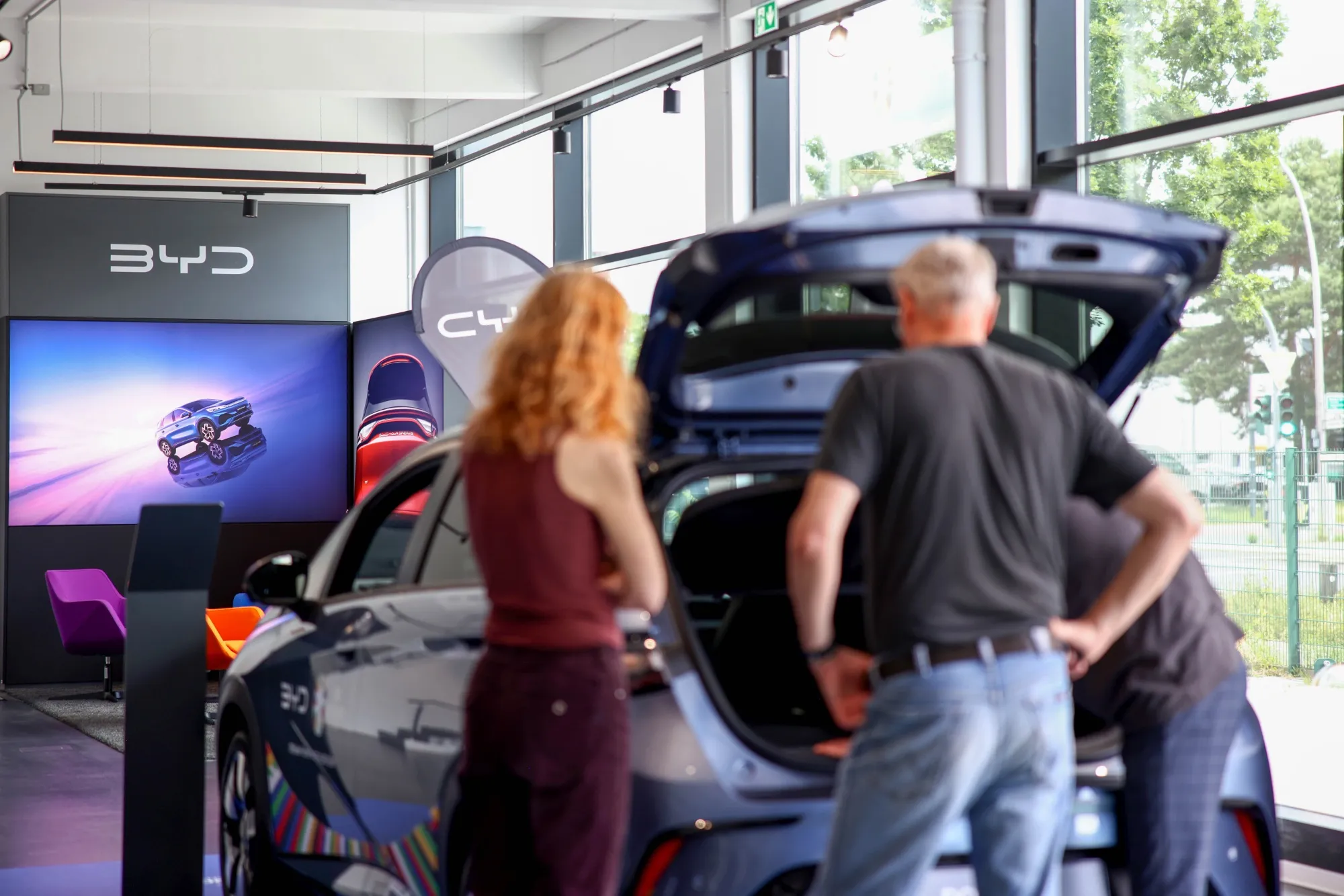 Customers look at electric vehicles at a BYD showroom in Berlin, Germany.