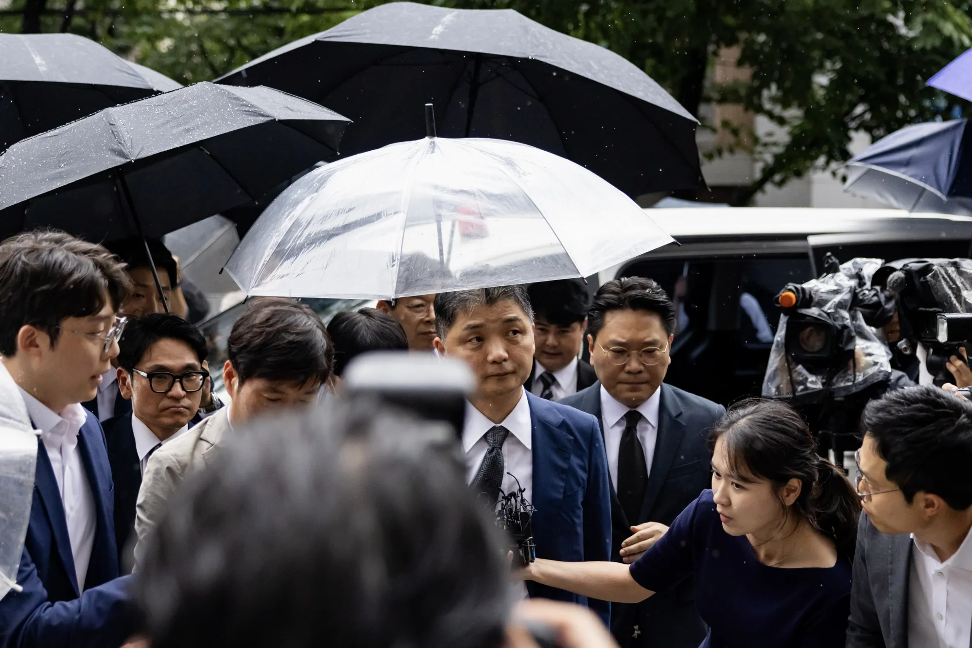 Brian Kim, center, outside the Seoul Southern District Court on July 22.