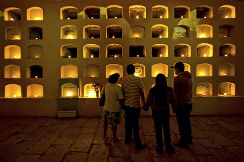 Paying respects at the candle-lit crypt of San Miguel in Oaxaca.