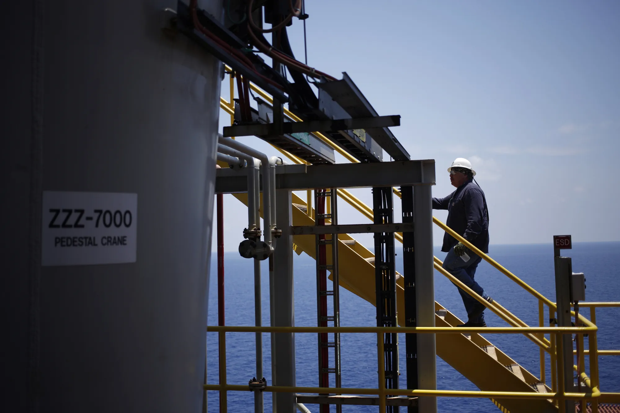 A offshore worker climbs a staircase on&nbsp;&nbsp;deepwater oil platform in the Gulf of Mexico off the coast of Louisiana, US.