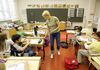 A teacher giving rulers to children in Finland. The Nordic country’s education system is a prime reason it scores at the top of the “Years of Good Life (YoGL)” economic index