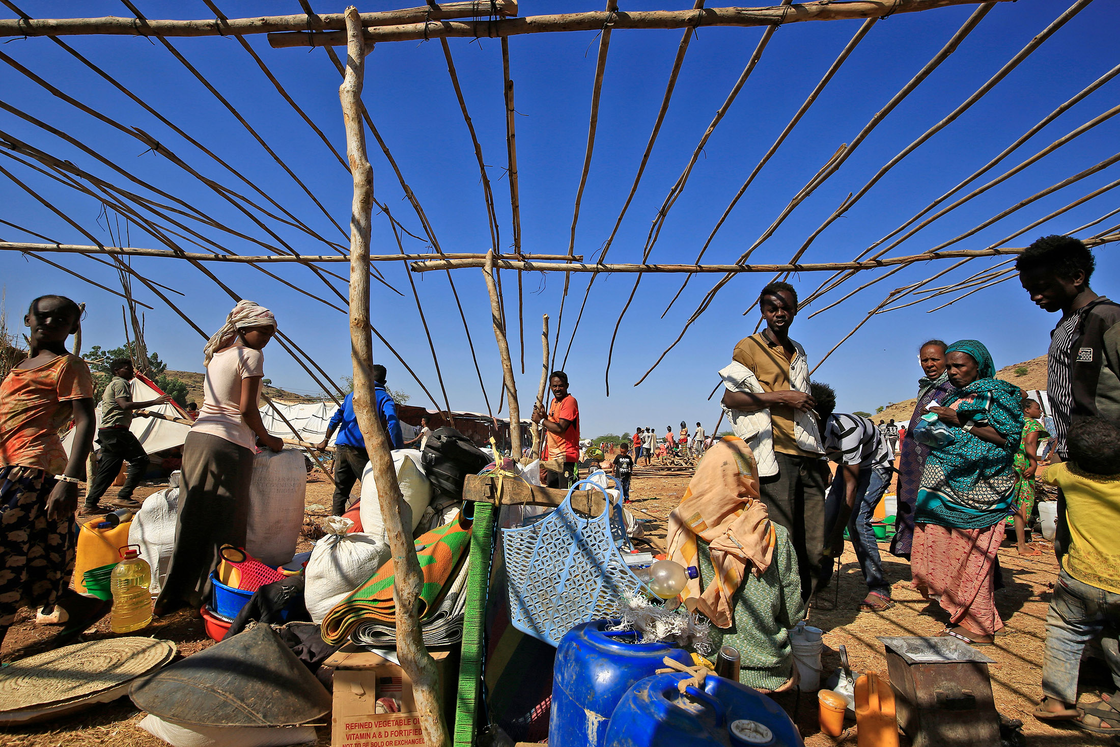 Ethiopian refugees who fled the Tigray conflict, start building temporary huts at Um Raquba camp in Sudan's eastern Gedaref province on Nov.&nbsp;28.