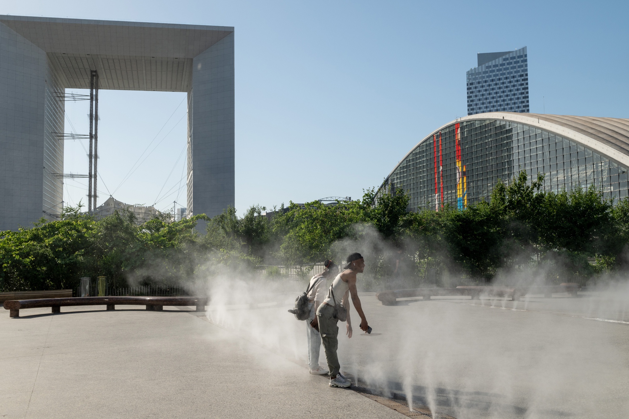 Workers cool themselves in water fountains during high temperatures in Paris in May.