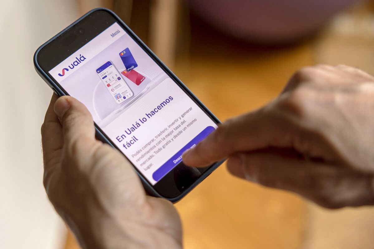 Person using Ualá mobile app for financial transactions