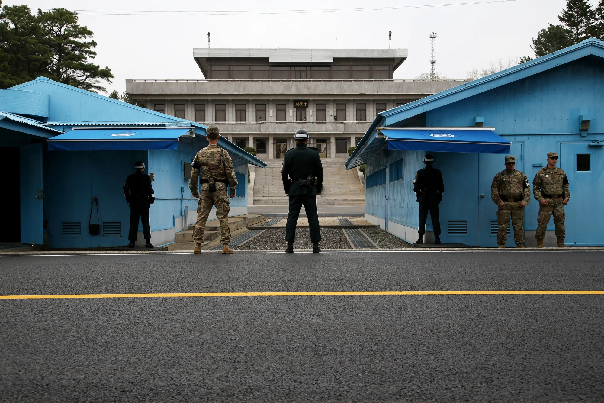 U.S. and South Korean soldiers stand guard next to the meeting rooms that straddle the border between the two Koreas in the truce village of Panmunjom in the Demilitarized Zone in Paju, South Korea.