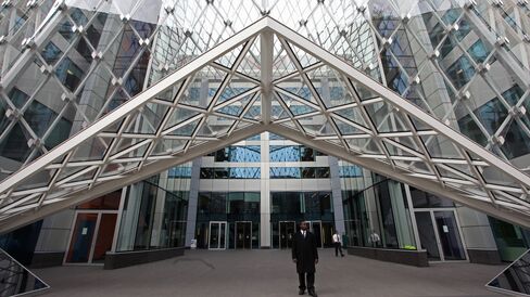 A security guard stands outside the building housing the offices of Brevan Howard Asset Management LP, in London.