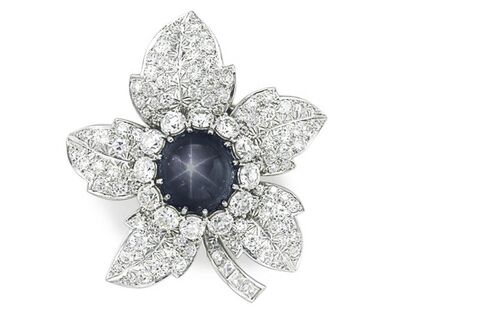 A sapphire and diamond brooch.