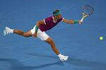 Rafael Nadal of Spain plays a forehand return to Matteo Berrettini of Italy during their semifinal match at the Australian Open tennis championships in Melbourne, Australia, Friday, Jan. 28, 2022. (AP Photo/Tertius Pickard)