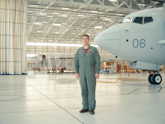 Squadron Leader Lamb beside a Poseidon.