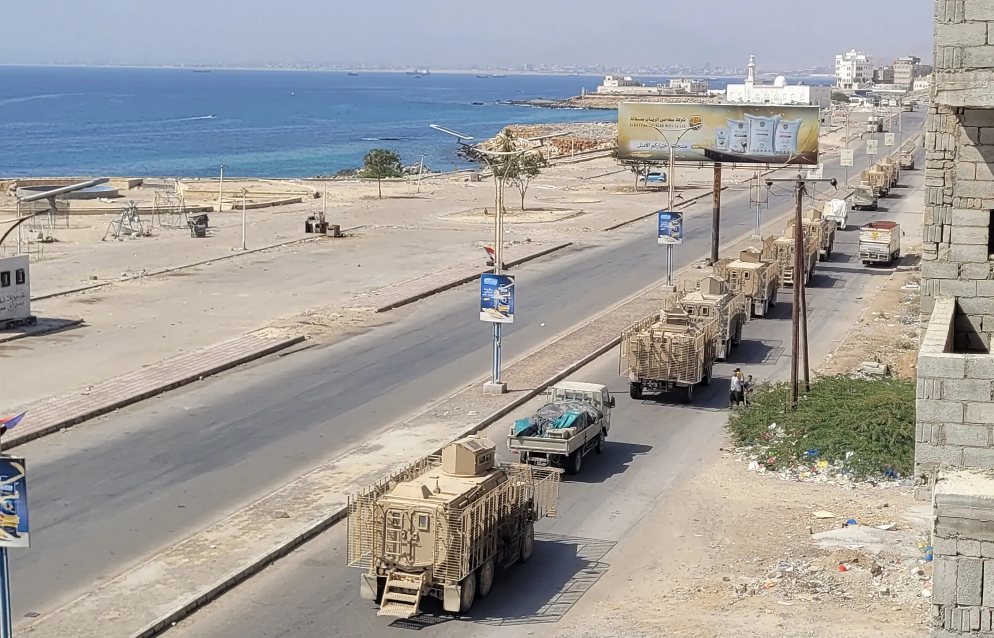 A convoy of armoured vehicles makes its way along a street in the port city Mukalla, southern Yemen, on Jan. 1.