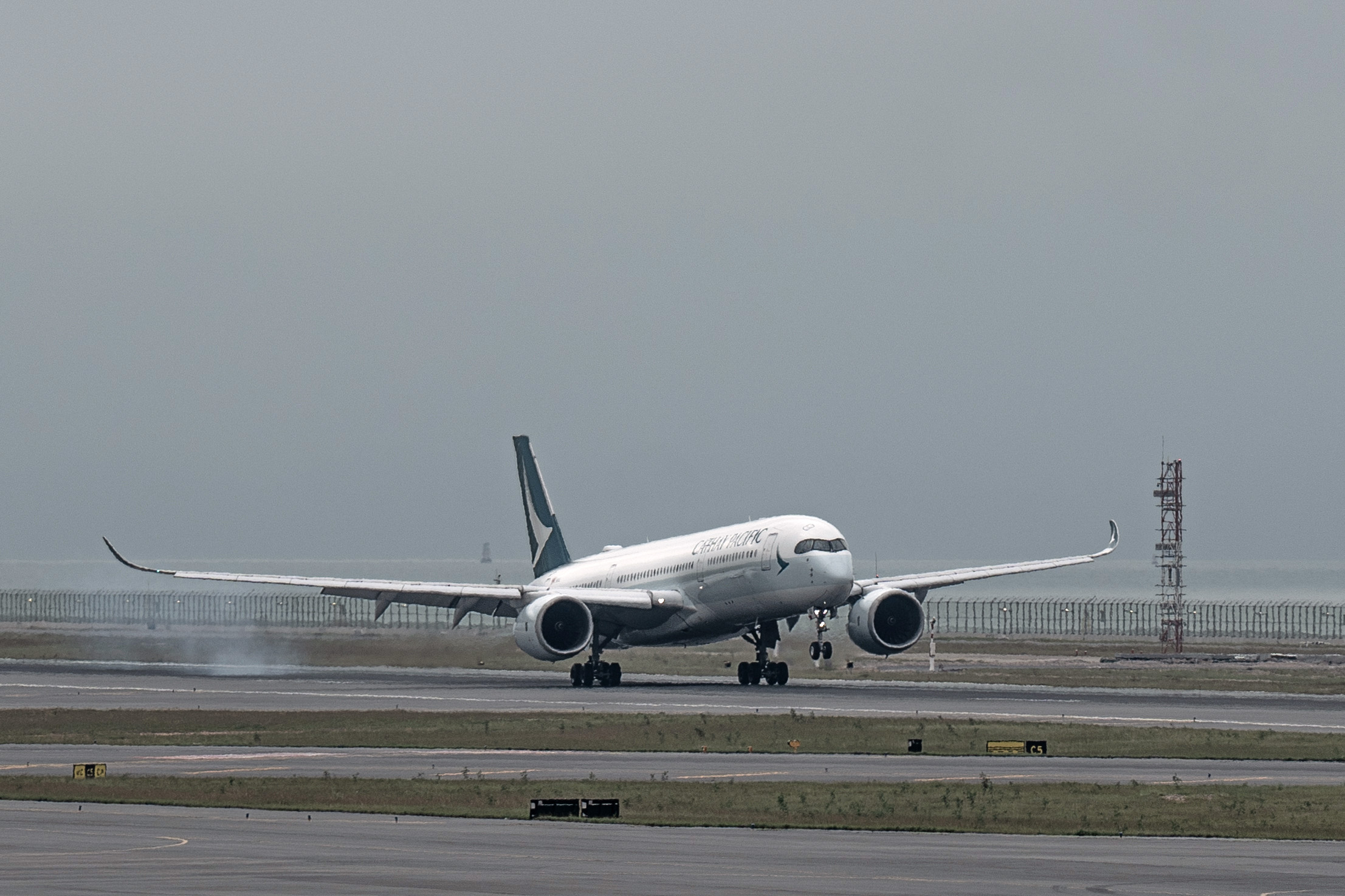 A Cathay Pacific aircraft lands on the third runway at Hong Kong International Airport&nbsp;on Nov. 25.