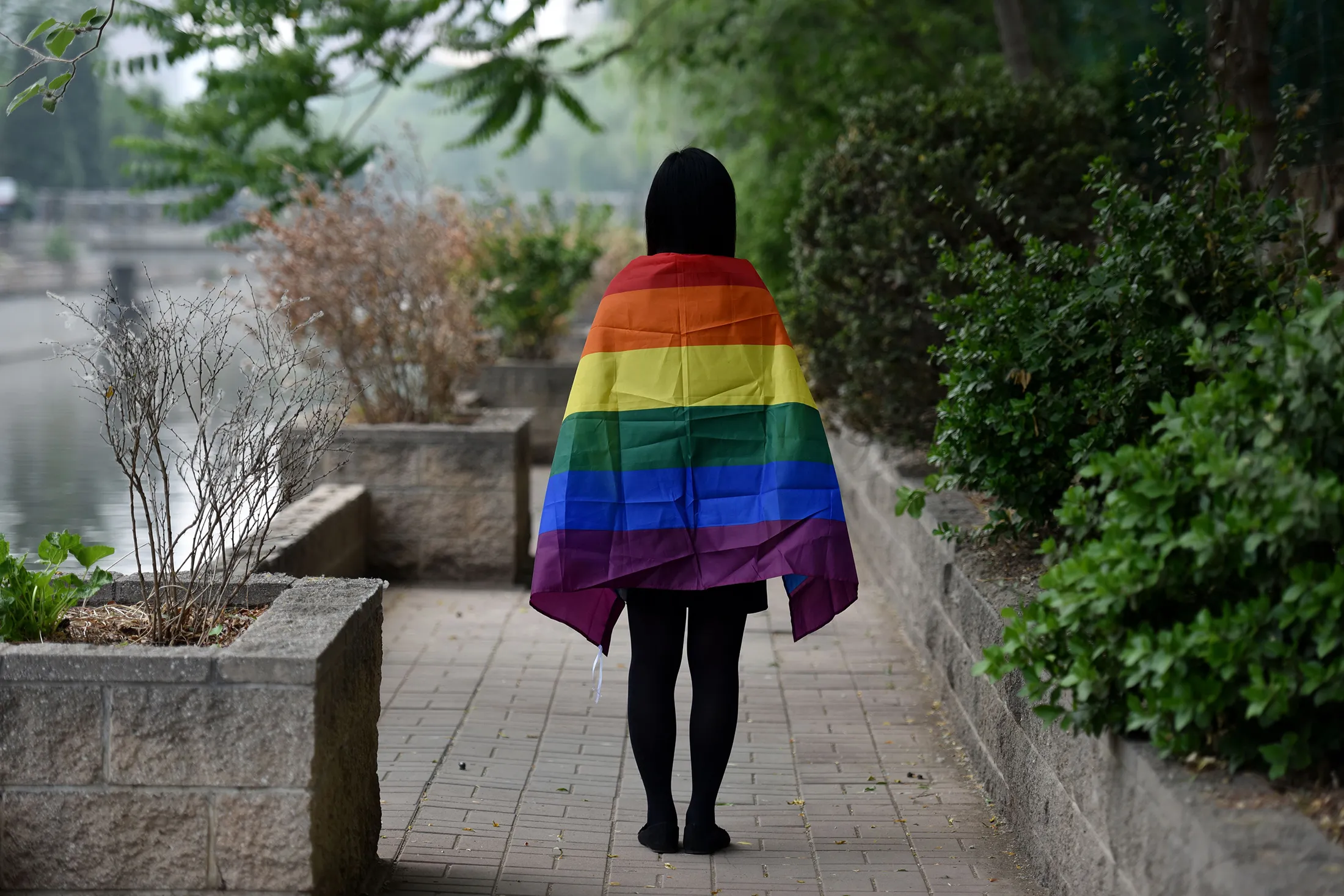 A gay student poses with a rainbow flag in Beijing.