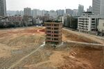 A six-floor &quot;nail house&quot; on a construction site in the central business district of Shenzhen April 17, 2007. 