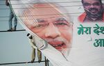 Indian labourers hang a banner bearing the image of Indian Prime Minister Narendra Modi ahead of the forthcoming Parivartan Rally in Allahabad on June 9. Modi has opened sectors such as railways and defense, helping draw record foreign direct investment in 2015, narrowed the current-account gap by curbing gold imports, quickened infrastructure building and limited the budget deficit to a nine-year low.
