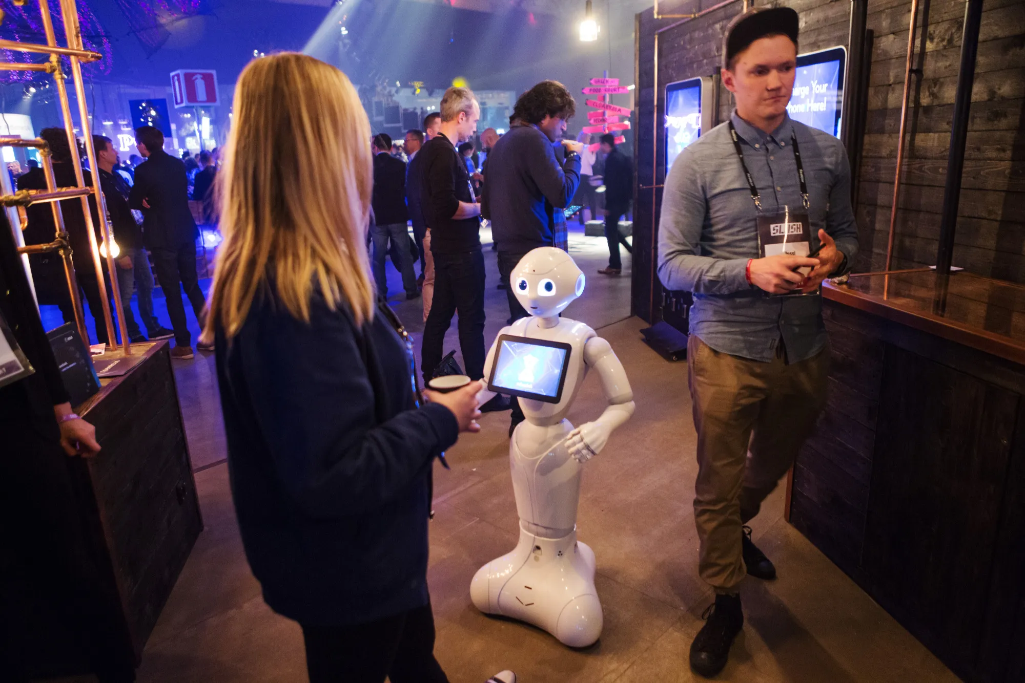 SoftBank's Pepper humanoid robot interacts with an attendee during the Slush startup&nbsp;event in Helsinki.