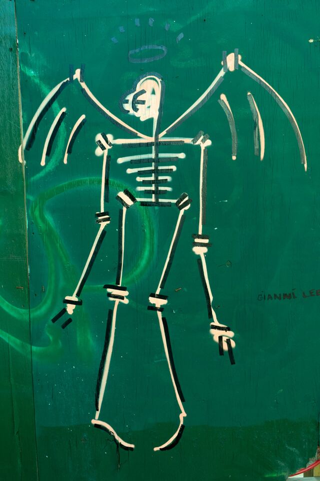 Skeleton angel wearing a mask by artist Gianni Lee at Woodbine Street and Broadway, Brooklyn
