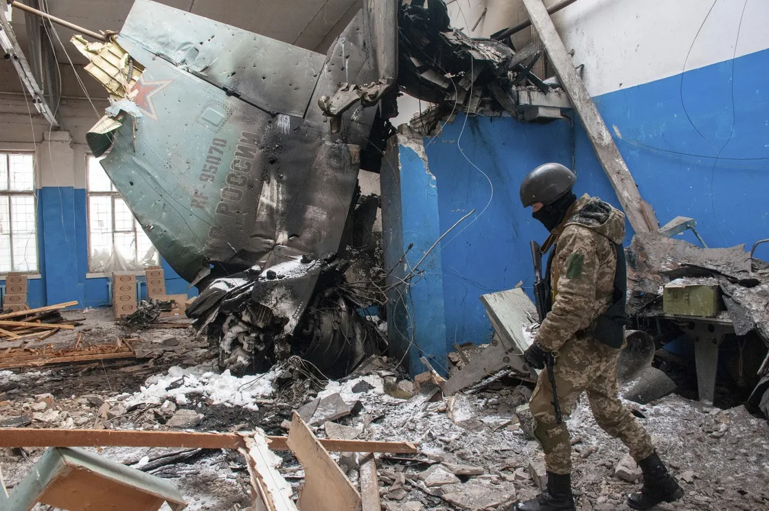 A Ukrainian serviceman walks past part of a downed Russian Su-34 bomber in Kharkiv, Ukraine, on March 8.