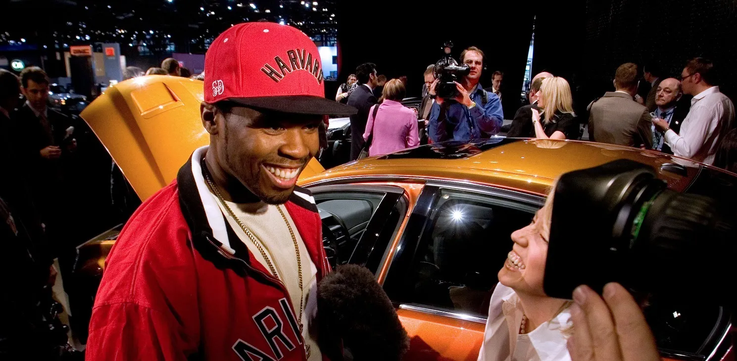 Rapper Fifty Cent smiles in an interview at the Pontiac stage during a media preview at the 2008 New York International Auto Show in New York, U.S., on Wednesday, March 19, 2008. The show is open to the public from March 21-30 at the Javits Center.