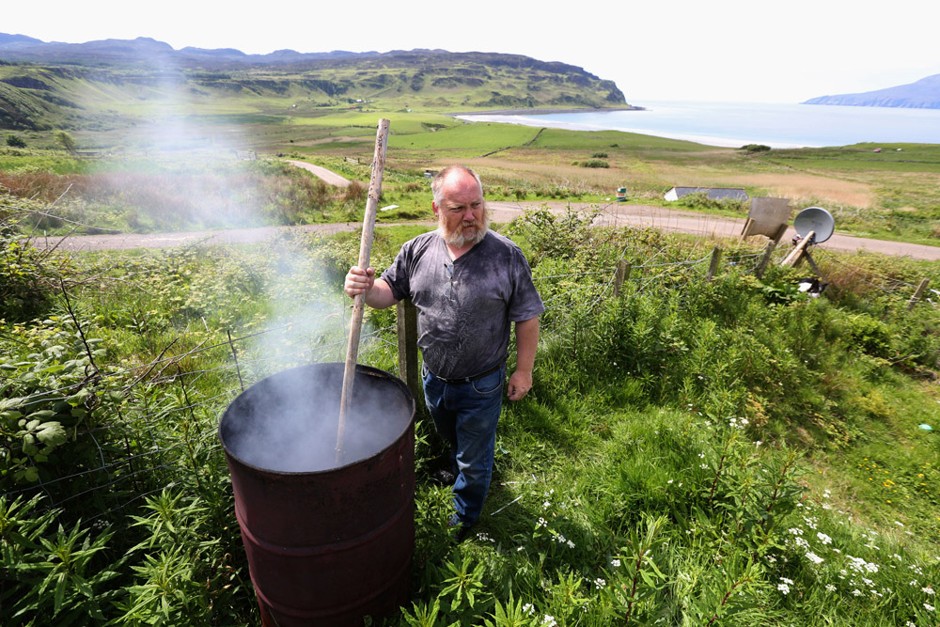 Charlie Galli burns trash as part of the Scottish island of Eigg's drive for sustainability.