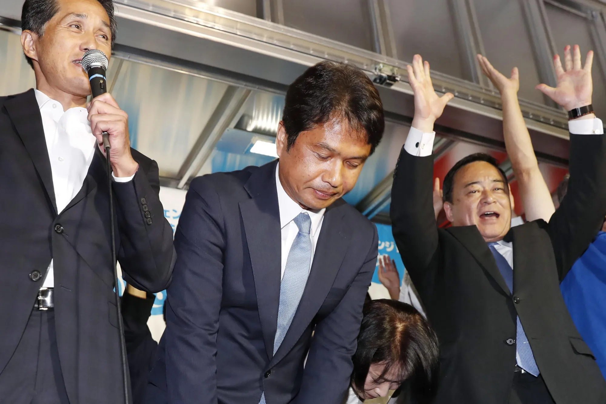 Kazuhiko Oigawa, second left, celebrates after winning the Ibaraki gubernatorial election in Mito, Japan, on Aug. 27.
