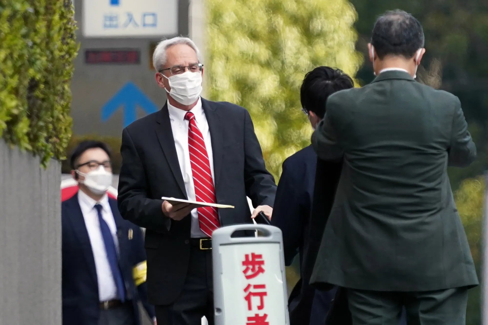 Greg Kelly, second from left, arrives at the Tokyo District Court on March 3.
