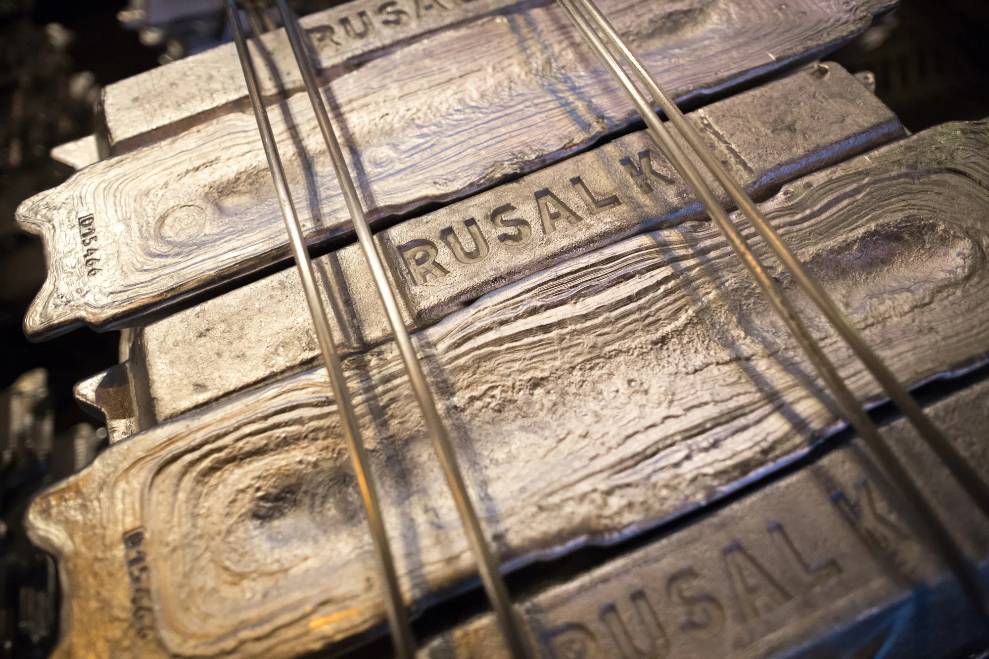 A Rusal logo stamp sits on an aluminum ingot awaiting shipment.