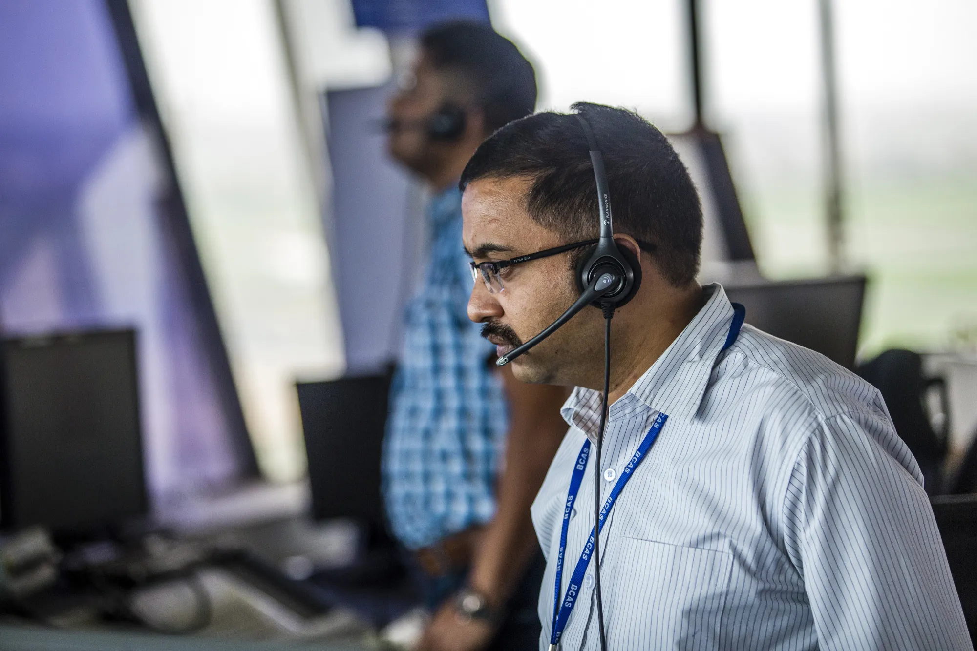 Air-traffic controllers work inside a control tower at Indira Gandhi International Airport in Delhi, India.