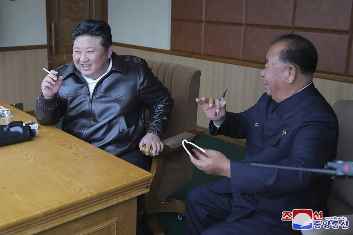 In this photo provided by the North Korean government, Kim Jong Un, left, inspects tests of drones designed to crash into targets, at an undisclosed location in North Korea, on Nov. 14.
