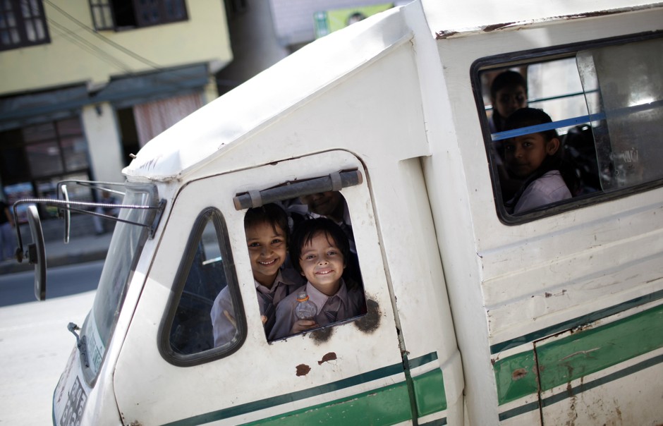 Kathmandu children return home from school on a Safa Tempo electric bus. Nepal was a leader in introducing EVs in public transportation.