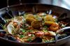 Paella Valenciana comes with shrimp, mussels, clams chorizo and calasparra rice at Toro in New York, U.S., on Monday, Nov. 11, 2013. The dish costs $38, or $76 for a larger portion.