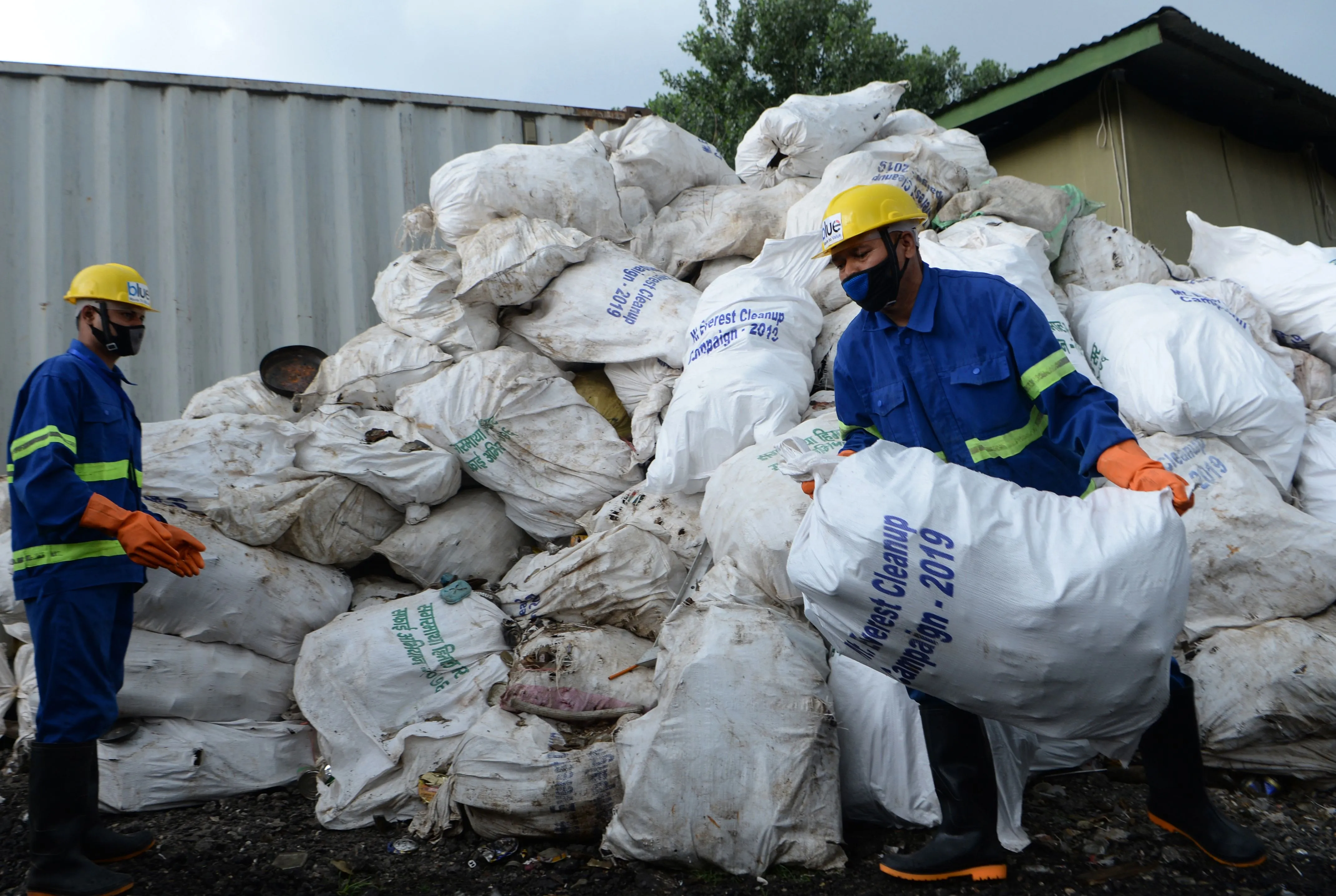 Workers pile up sacks of waste collected from Mount Everest for recycling, in Kathmandu on June 5.