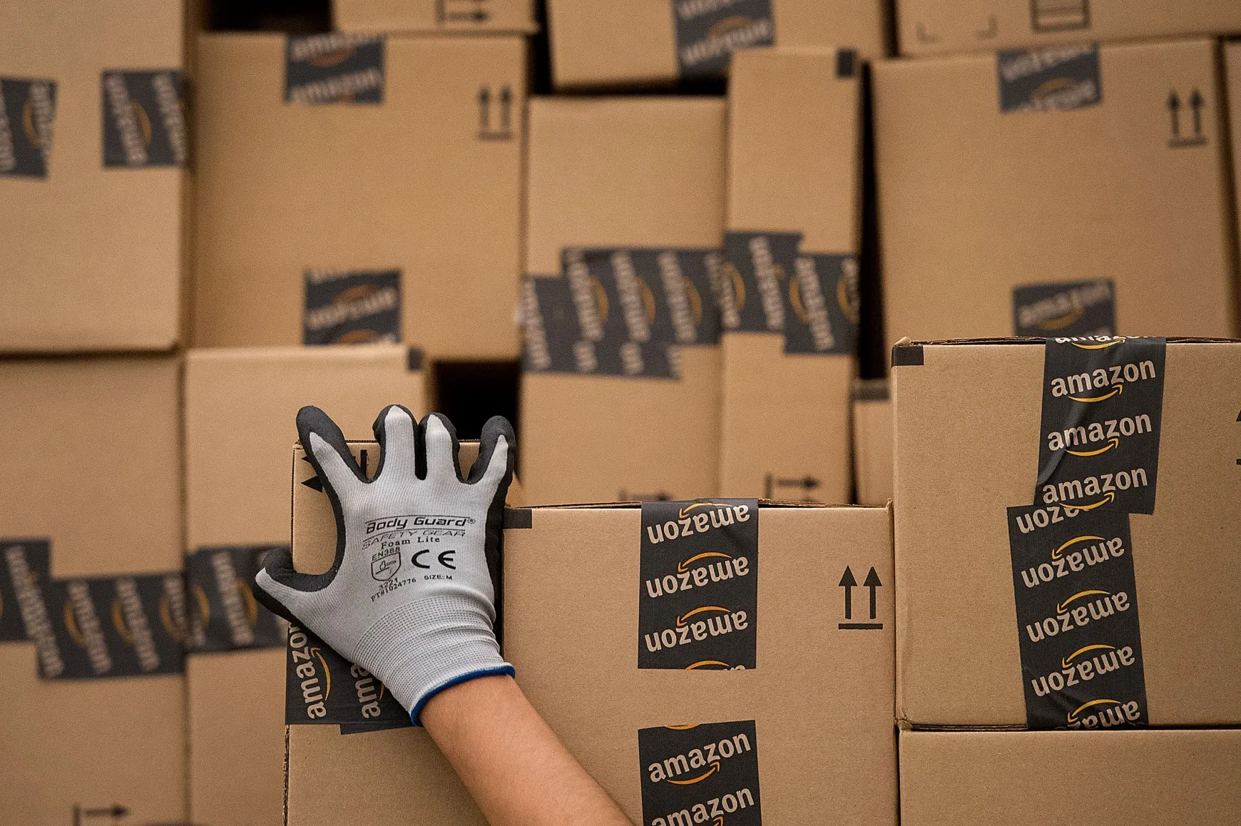 An employee loads a truck with boxes to be shipped at the Amazon.com Inc. distribution center in Phoenix, Arizona.