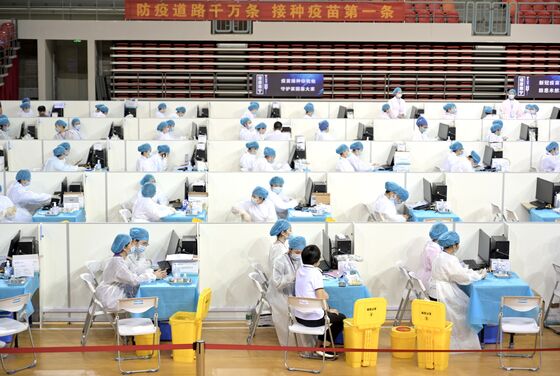 China Pushes Vaccine on Bankers, Colleges to Catch Up With U.S.