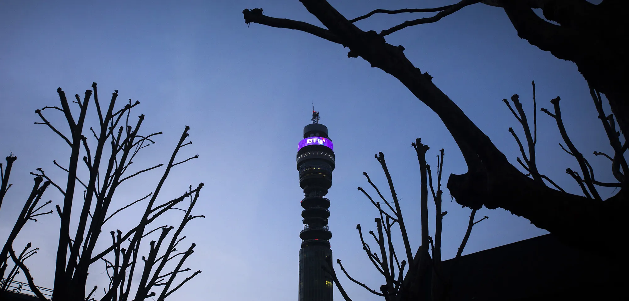 A BT logo sits above communications equipment on the BT Tower operated by BT Group Plc in London.