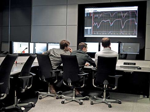 Engineers and programmers prepare the simulator for a test