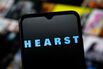 In this photo illustration, the Hearst Communications logo