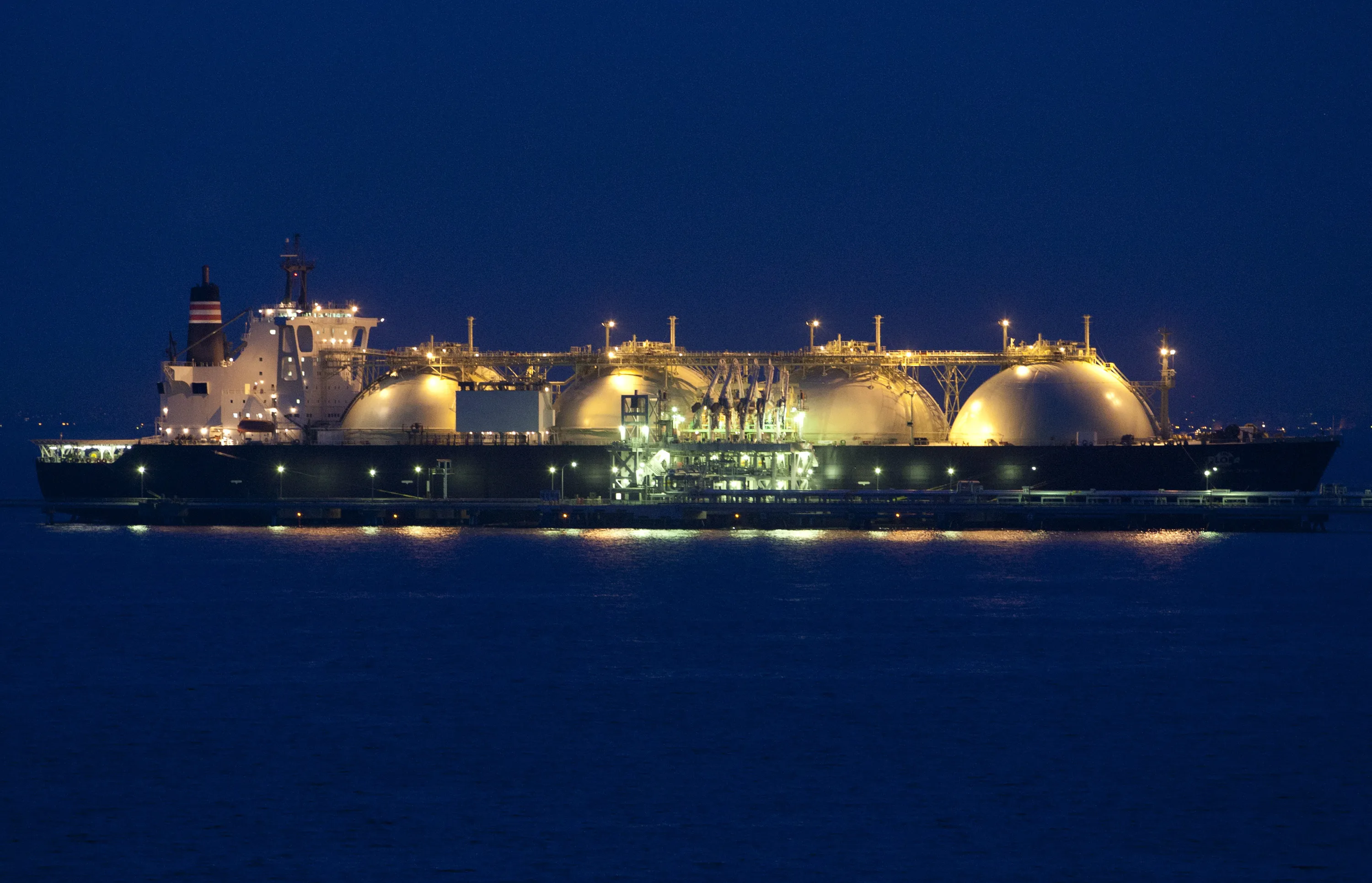 A LNG tanker moored at night in Japan.