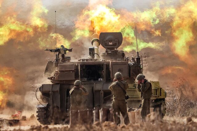 An Israeli army M109 155mm self-propelled howitzer fires rounds near the border with Gaza in southern Israel on October 11, 2023. 